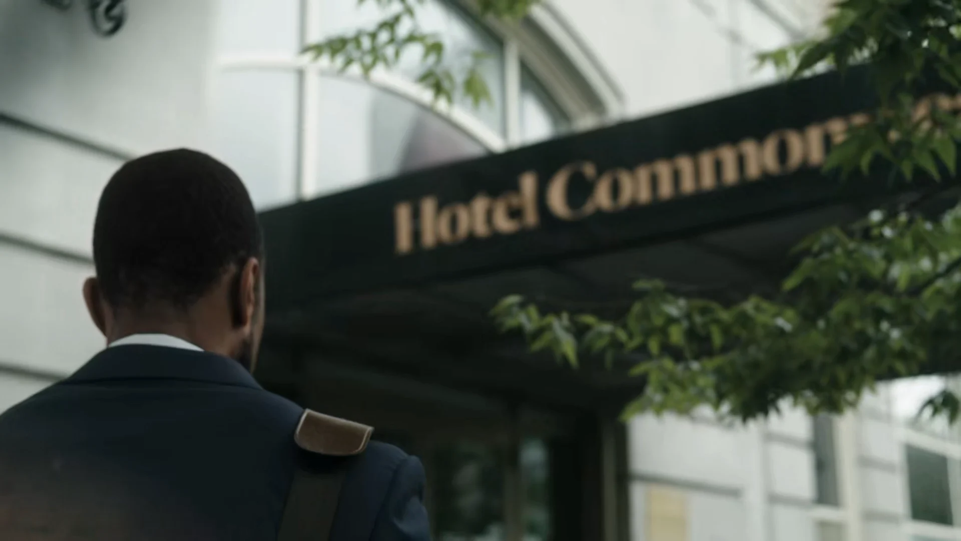 A guest arrives beneath the Hotel Commonwealth awning