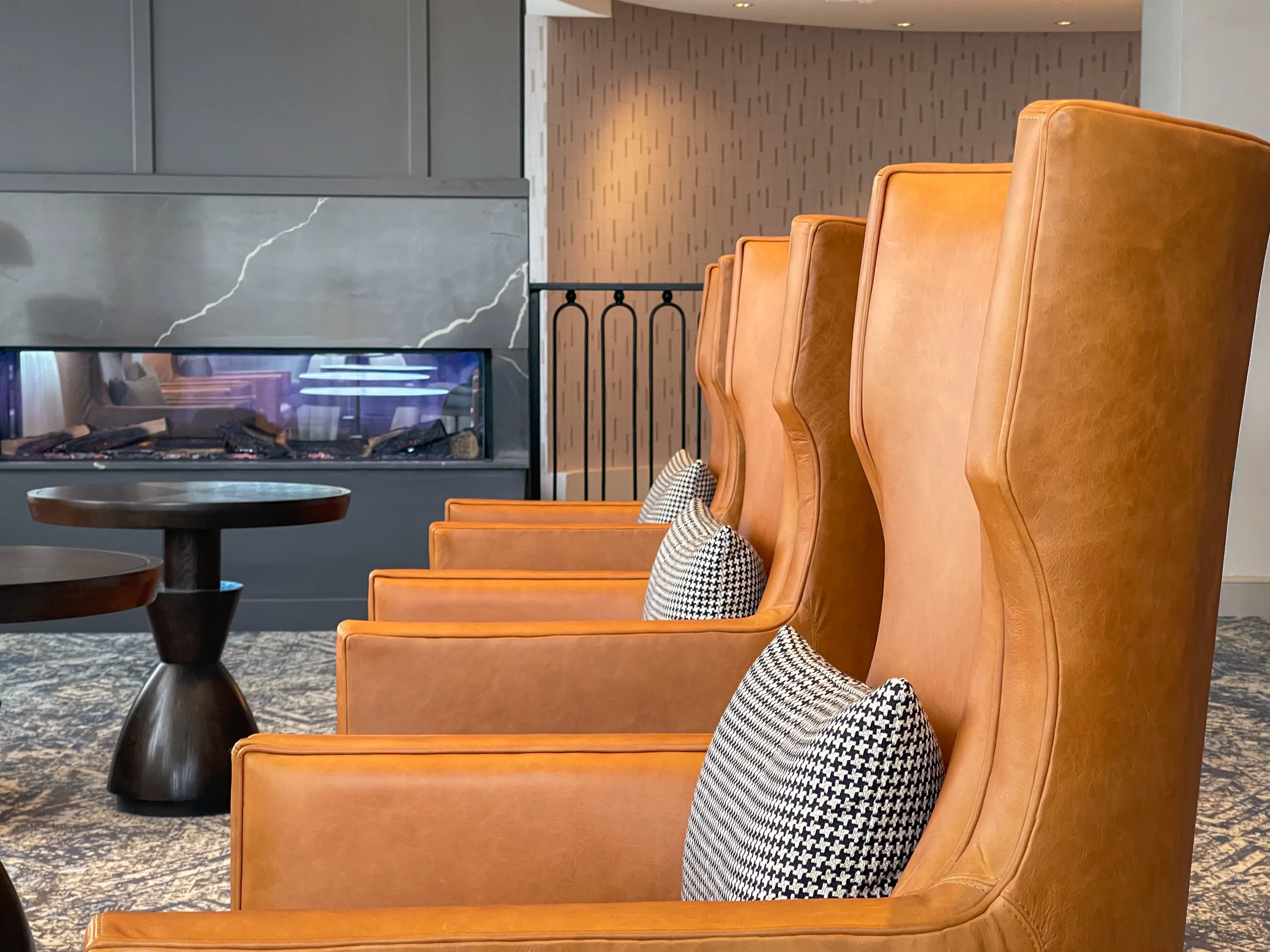 Leather wingback chairs beside the fireplace