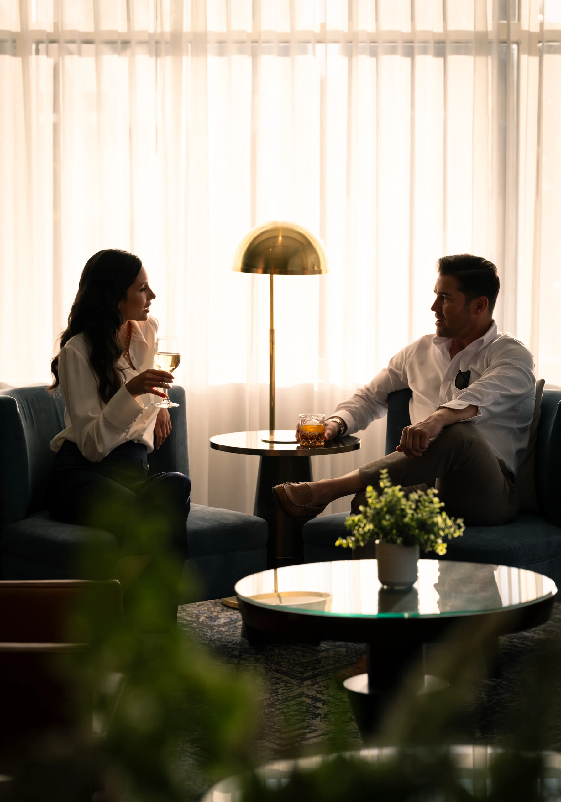 A couple talks over drinks in the lobby lounge