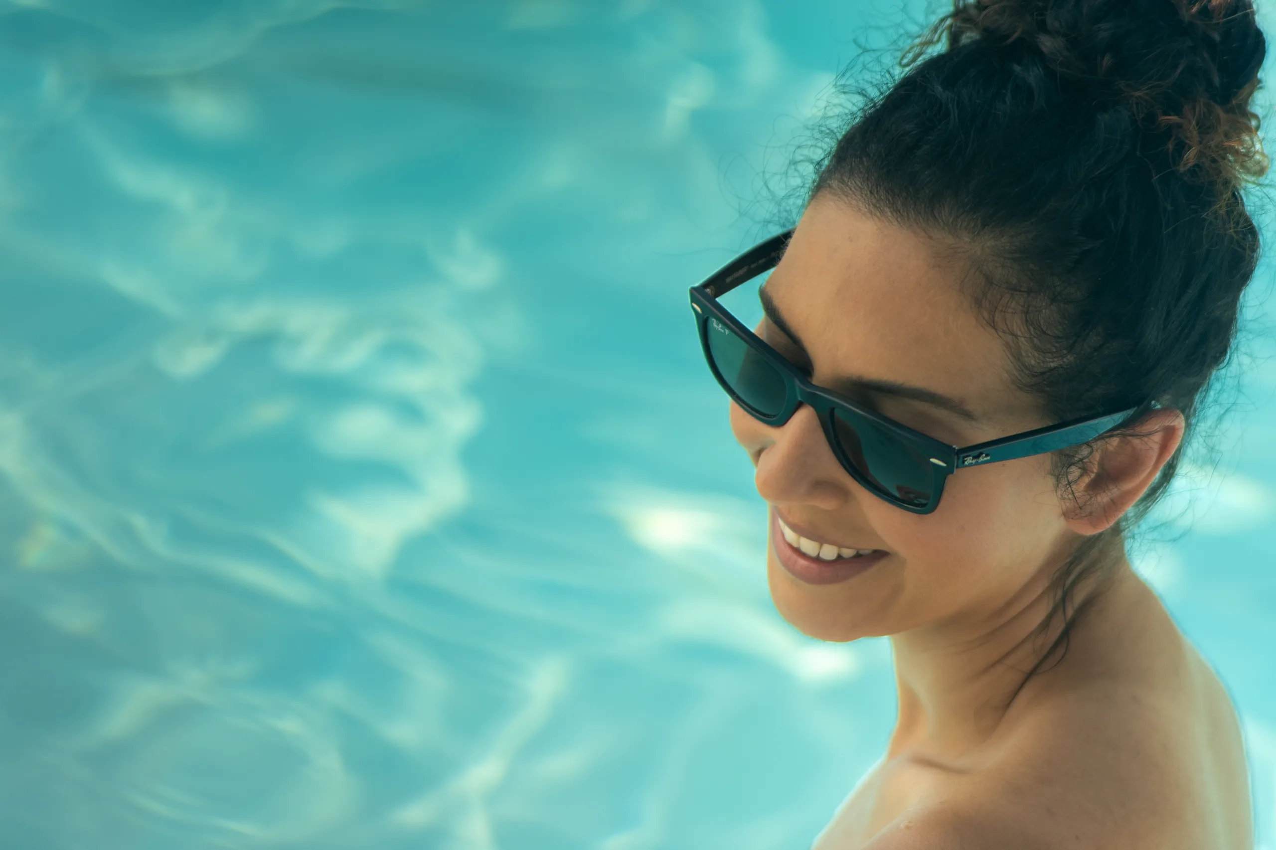 A guest in sunglasses by the pool