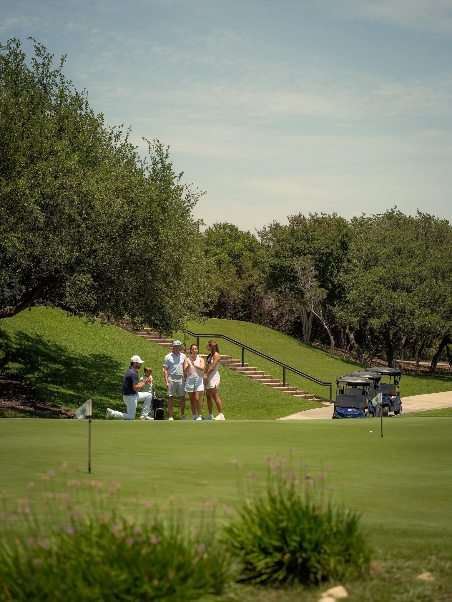 A family golf lesson on the putting green