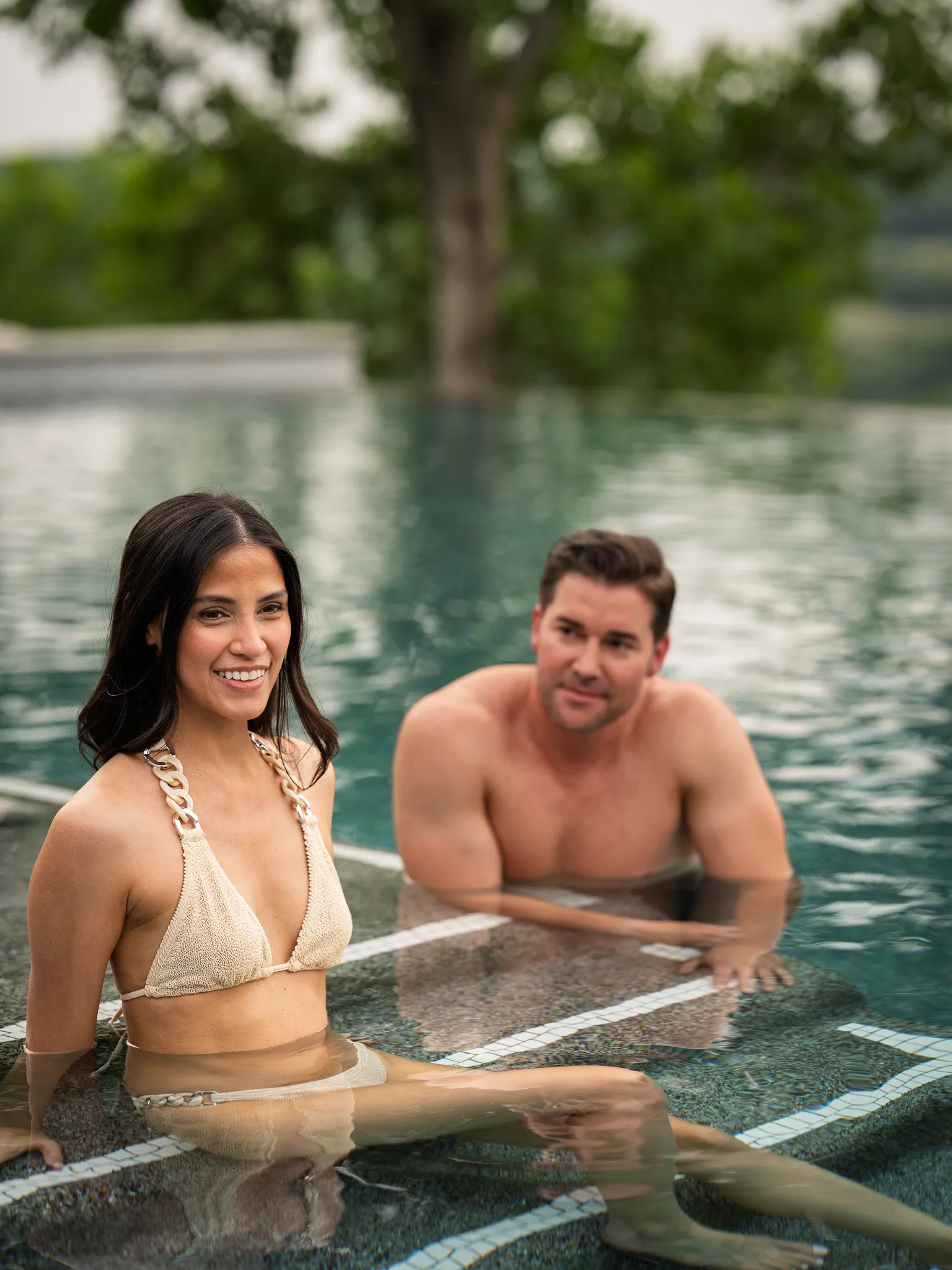 A couple relaxes in the Topaz adults-only pool