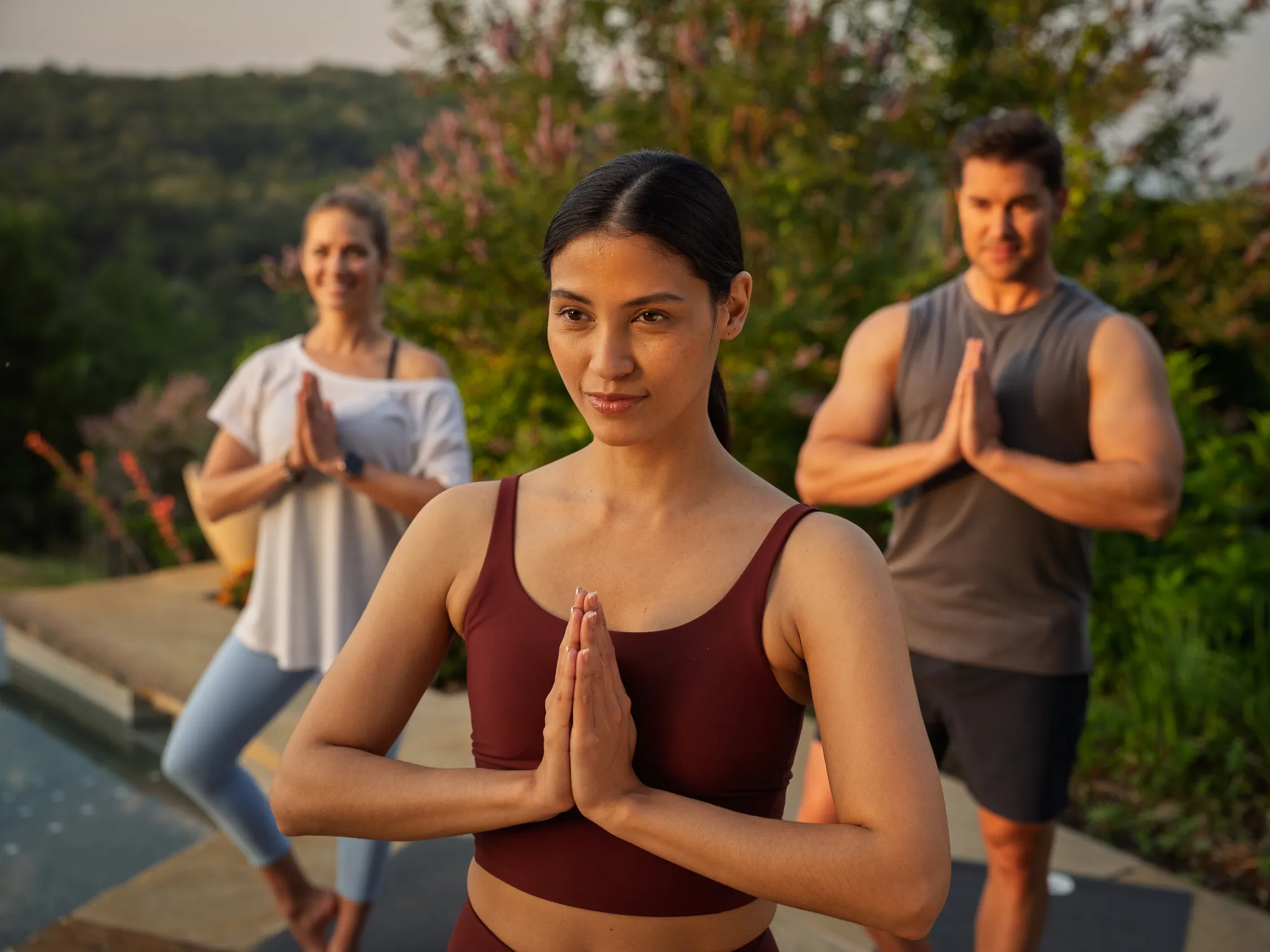 A guest in a terracotta top during sunrise yoga