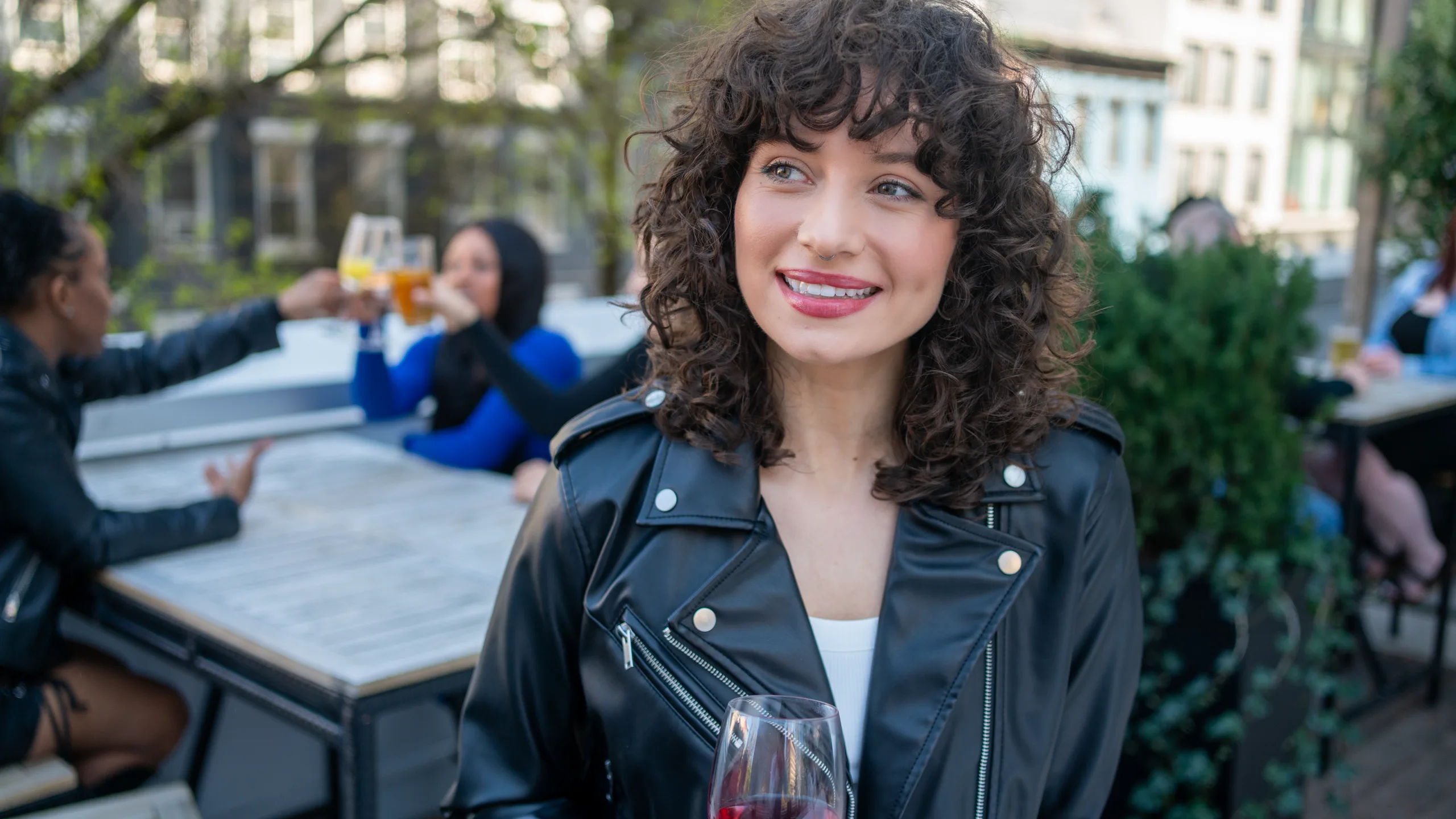 A guest with a glass of wine on the patio