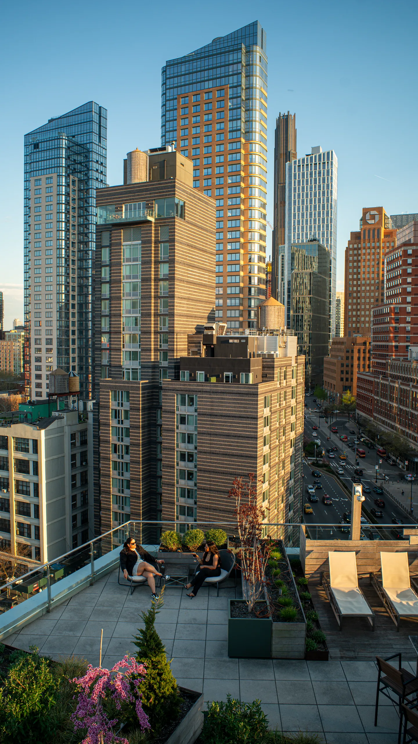 Two guests on the rooftop below the Downtown Brooklyn towers