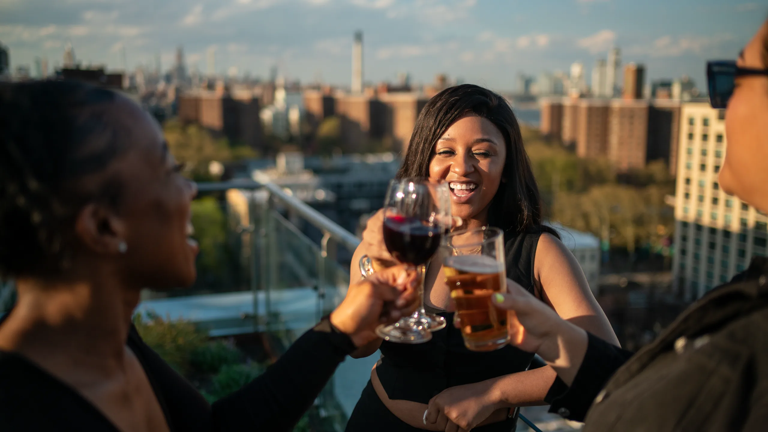 Friends toast on the rooftop at golden hour