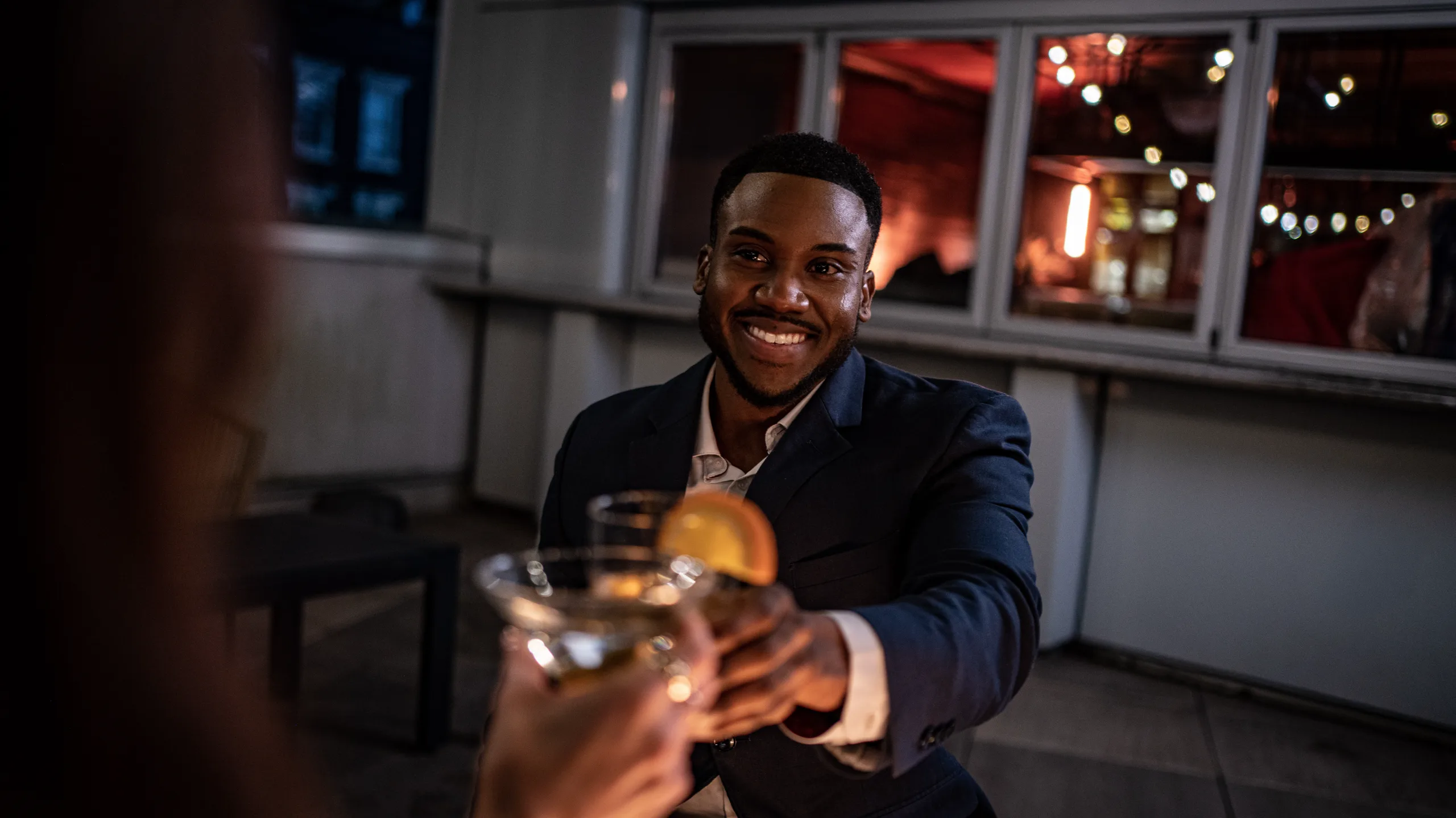 A guest toasts across the table on the terrace